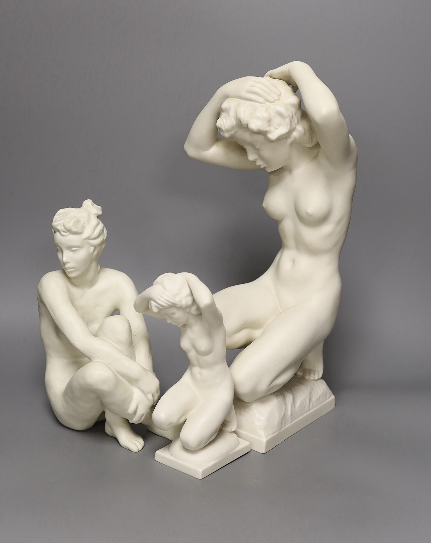 A Karl Tutter for Hutschenreuter bisque kneeling nude, a similar smaller nude and another by Rosenthal. Tallest 35cm